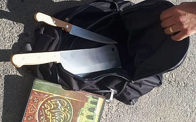 A meat cleaver, knife, and copy of the Quran, found in the backpack of a Palestinian man, who said they were going to be used in a terror attack near the Kochav Yaakov settlement in the central West Bank on November 9, 2017. (Israel Police)
