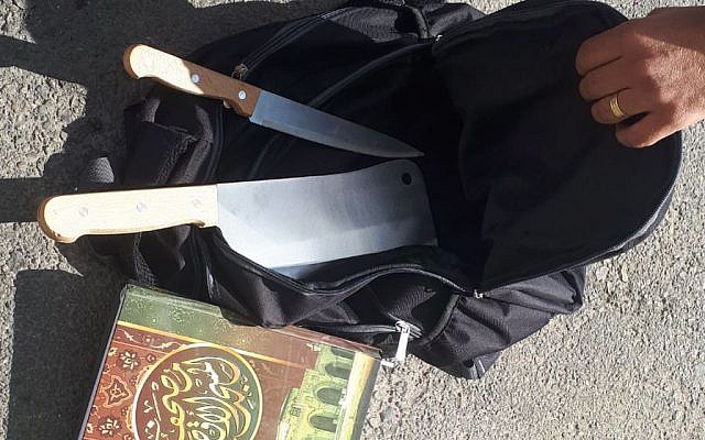 A meat cleaver, knife, and copy of the Quran, found in the backpack of a Palestinian man, who said they were going to be used in a terror attack near the Kochav Yaakov settlement in the central West Bank on November 9, 2017. (Israel Police)