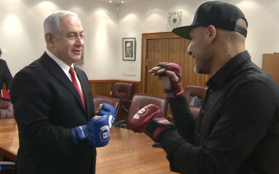 Prime Minister Benjamin Netanyahu spars with Israeli MMA fighter Noad Lahat at the Knesset on November 15, 2017. (Screen capture/YouTube)