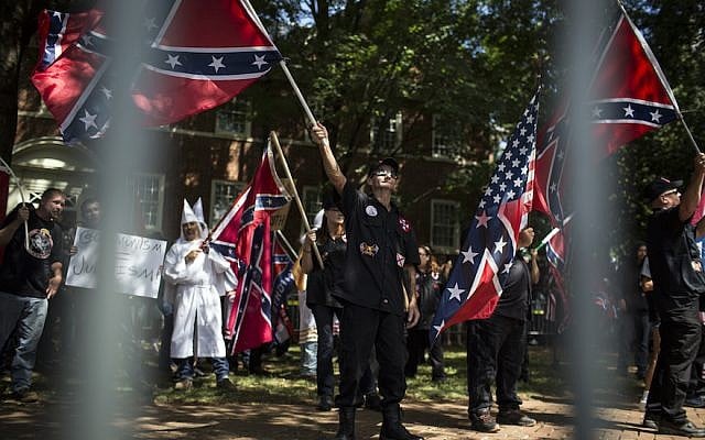 Ku Klux Klan members on July 8, 2017 in Charlottesville, Virginia protesting the planned removal of a statue of General Robert E. Lee, and calling for the protection of Southern Confederate monuments. (Chet Strange/Getty Images via JTA) Ku Klux Klan members on July 8, 2017 in Charlottesville, Virginia protesting the planned removal of a statue of General Robert E. Lee, and calling for the protection of Southern Confederate monuments. (Chet Strange/Getty Images via JTA)