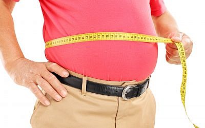Illustrative: A man measures his belly. (Ljupco/ iStock via Getty images)
