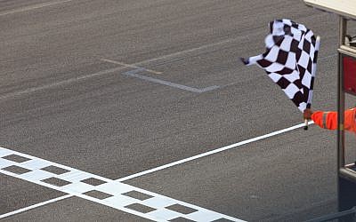 A checkered flag waving at an car race. (iStock/Getty Images/AvigatorPhotographer)