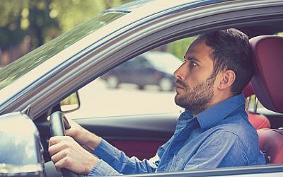 A stressed man driving a car. (SIphotography/iStock/Getty Images)