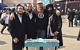 Eitan Press, second from right, says he has “anointed” the beards of hundreds of men, including these Jewish pilgrims in Uman, Ukraine, Sept. 20, 2017. (Aleph Male)