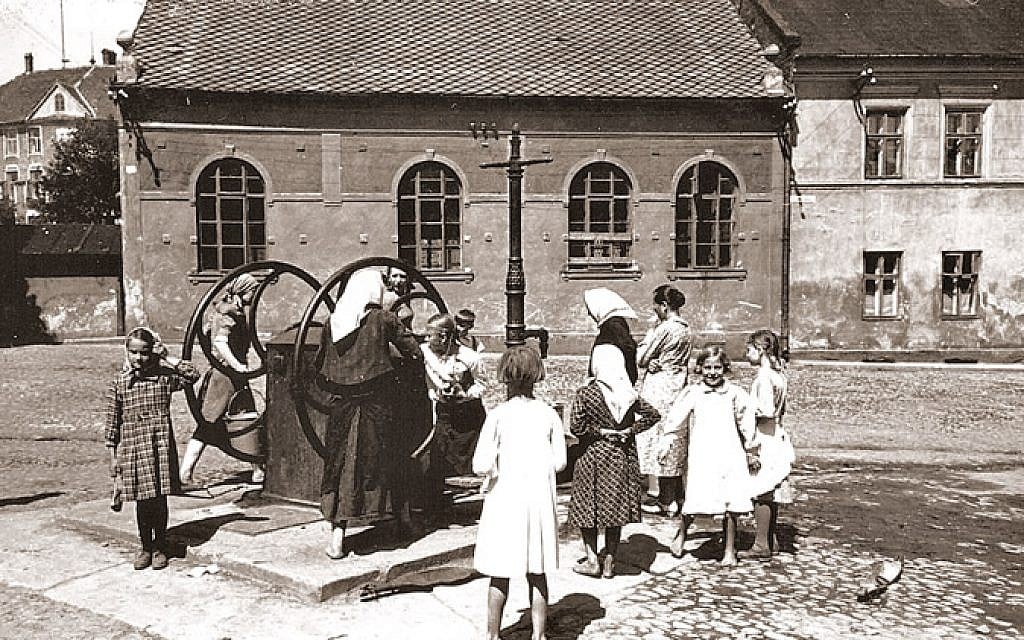 Illustrative: In Oswiecim, Poland, a water well is used in front of the so-called 'Auschwitz Synagogue' near the center of town, during the interwar period (Auschwitz Jewish Center)