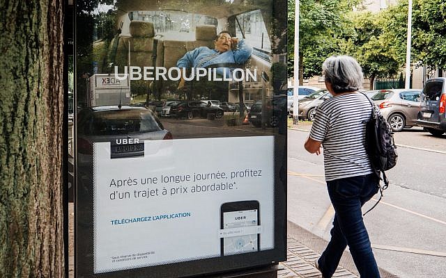 Uber advertising for taxi service at bus station (Credit: AdrianHancu, iStock by Getty Images)