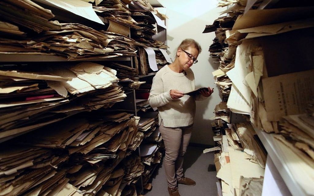 Judaica Research Centre chief Lara Lempertiene stands amid rediscovered Jewish documents, long thought to have been destroyed during World War II, at the Lithuanian national library in Vilnius on November 3, 2017. (AFP/Petras Malukas)