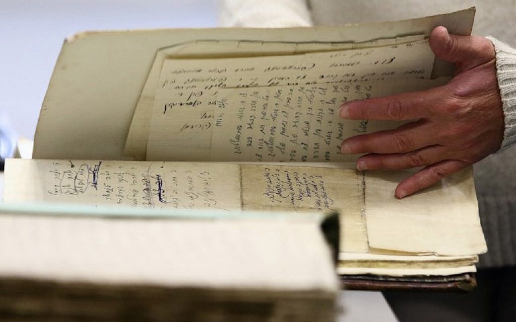 Judaica Research Centre chief Lara Lempertiene shows rediscovered Jewish documents, long thought to have been destroyed during World War II, in Lithuanian national library in Vilnius on November 3, 2017. (AFP PHOTO / Petras Malukas)