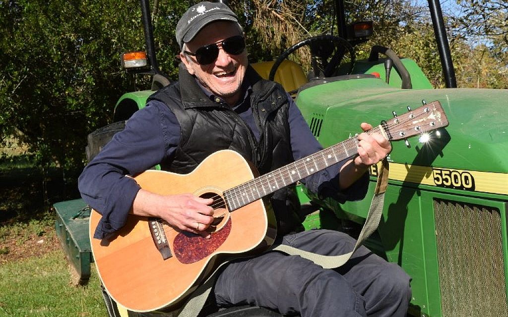 This photo taken on November 14, 2017 shows US country musician Daniel Antopolsky playing guitar on a tractor in Fargues-Saint-Hilaire, near Bordeaux, southwestern France where he settled down in the 90s. (AFP PHOTO / MEHDI FEDOUACH) This photo taken on November 14, 2017 shows US country musician Daniel Antopolsky playing guitar on a tractor in Fargues-Saint-Hilaire, near Bordeaux, southwestern France where he settled down in the 90s. (AFP PHOTO / MEHDI FEDOUACH)
