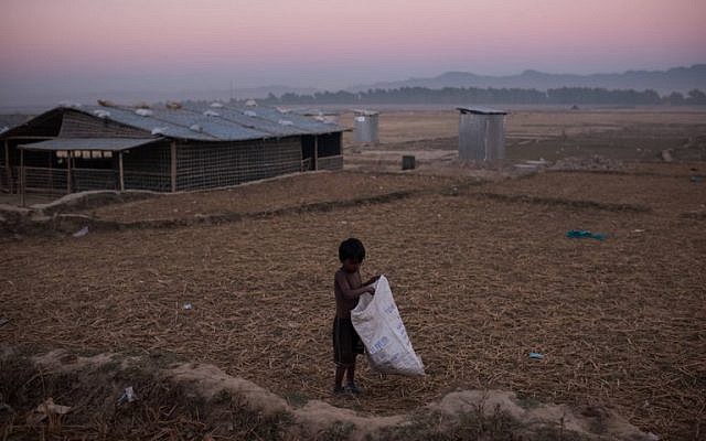 A Rohingya boy gathers grass stalks at the Naybara refugee camp, in Cox's Bazar on December 3, 2017. (AFP Photo/Ed Jones) A Rohingya boy gathers grass stalks at the Naybara refugee camp, in Cox's Bazar on December 3, 2017. (AFP Photo/Ed Jones)