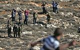 Illustrative: Palestinians clash with Israeli soldiers and settlers at the entrance to the northern West Bank village of Qusra on December 4, 2017. (AFP Photo/Jaafar Ashtiyeh)