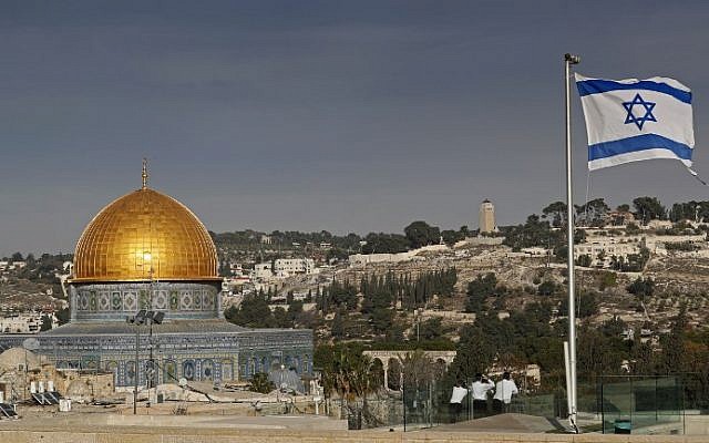 An Israeli flag flutters on the roof of a building of the Jewish Quarter in the Old City of Jerusalem, as the Dome of the Rock is seen in the background, on December 5, 2017. (AFP Photo/Thomas Coex) An Israeli flag flutters on the roof of a building of the Jewish Quarter in the Old City of Jerusalem, as the Dome of the Rock is seen in the background, on December 5, 2017. (AFP Photo/Thomas Coex)