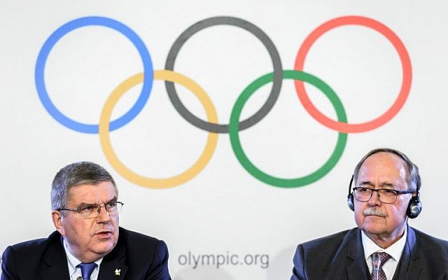 International Olympic Committee (IOC) President Thomas Bach (L) and chair of IOC Inquiry Commission into alleged Russian doping at Sochi 2014, Samuel Schmid, attend a press conference following an executive meeting on Russian doping, on December 5, 2017 in Lausanne, Switzlerland. (AFP Photo/Fabrice Coffrini) International Olympic Committee (IOC) President Thomas Bach (L) and chair of IOC Inquiry Commission into alleged Russian doping at Sochi 2014, Samuel Schmid, attend a press conference following an executive meeting on Russian doping, on December 5, 2017 in Lausanne, Switzlerland. (AFP Photo/Fabrice Coffrini)