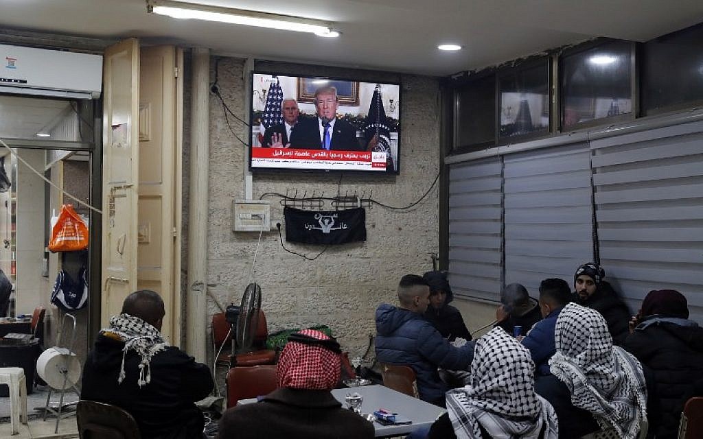 Palestinians sitting in a Jerusalem cafe watching an address given by US President Donald Trump about the city, December 6, 2017  (Ahmad GHARABLI/AFP)