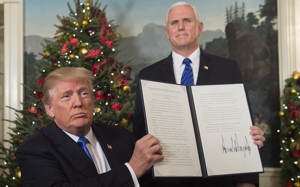 US President Donald Trump holds up a signed memorandum recognizing Jerusalem as Israel's capital, as US Vice President looks on, at the White House, on December 6, 2017. (AFP Photo/Saul Loeb) US President Donald Trump holds up a signed memorandum recognizing Jerusalem as Israel's capital, as US Vice President looks on, at the White House, on December 6, 2017. (AFP Photo/Saul Loeb)