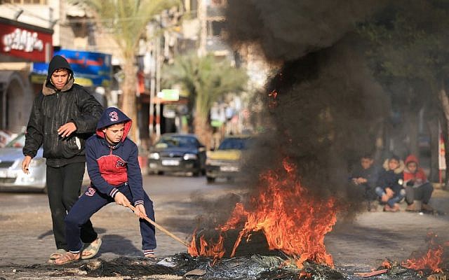 Palestinian youths set tires ablaze during a protest against US President Donald Trump's decision to recognize Jerusalem as the capital of Israel, in Gaza City, December 7, 2017. (MOHAMMED ABED/AFP) Palestinian youths set tires ablaze during a protest against US President Donald Trump's decision to recognize Jerusalem as the capital of Israel, in Gaza City, December 7, 2017. (MOHAMMED ABED/AFP)