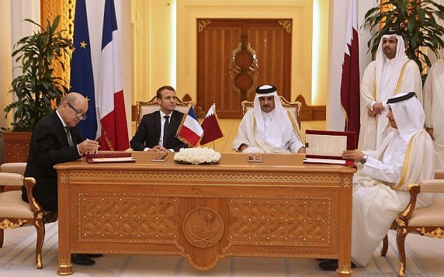 French President Emmanuel Macron (C-L), Qatari Emir Sheikh Tamim bin Hamad al-Thani (C-R) watch French Foreign Minister Jean-Yves Le Drian and his Qatari counterpart Mohammed bin Abdulrahman al-Thani (R) sign bilateral agreements in the Qatari capital Doha on December 7, 2017. (AFP/Karim Jaafar) French President Emmanuel Macron (C-L), Qatari Emir Sheikh Tamim bin Hamad al-Thani (C-R) watch French Foreign Minister Jean-Yves Le Drian and his Qatari counterpart Mohammed bin Abdulrahman al-Thani (R) sign bilateral agreements in the Qatari capital Doha on December 7, 2017. (AFP/Karim Jaafar)