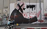 Palestinian children look at graffiti depicting US President Donald Trump and slogans against US Vice President Mike Pence painted on Israel's security barrier in the West Bank city of Bethlehem during clashes with Palestinian protesters near an Israeli checkpoint on December 7, 2017. (AFP/Thomas Coex)