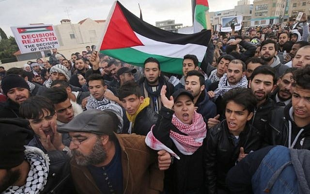 Protesters shout slogans and wave the Jordanian flag during a demonstration near the American Embassy in Amman against US President Donald Trump's decision to recognize Jerusalem as the capital of Israel on December 7, 2017. (AFP/Khalil Mazraawi) Protesters shout slogans and wave the Jordanian flag during a demonstration near the American Embassy in Amman against US President Donald Trump's decision to recognize Jerusalem as the capital of Israel on December 7, 2017. (AFP/Khalil Mazraawi)