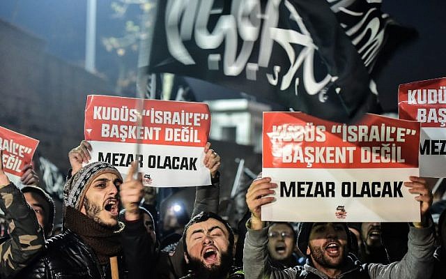 Protesters shout anti-USA and anti-Israel slogans as they hold placards reading 'Jerusalem will not be a capital to Israel, it will be a grave' during a demonstration after the US president recognized Jerusalem as Israel's capital in Istanbul on December 7, 2017. (AFP/Yasin Akgul) Protesters shout anti-USA and anti-Israel slogans as they hold placards reading 'Jerusalem will not be a capital to Israel, it will be a grave' during a demonstration after the US president recognized Jerusalem as Israel's capital in Istanbul on December 7, 2017. (AFP/Yasin Akgul)