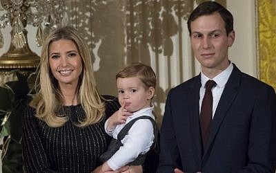 Ivanka Trump holds her son Theodore. center, alongside Jared Kushner, right, senior White House adviser, attends a Hanukkah reception hosted by US President Donald Trump in the East Room of the White House in Washington, DC, December 7, 2017. (SAUL LOEB/AFP)