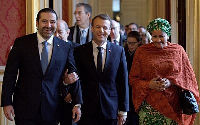 French President Emmanuel Macron (C) walks between Lebanon's Prime Minister Saad Hariri (L) and UN Deputy Secretary General Amina Mohammed (R) as they arrive to attend the Lebanon International Support Group meeting in Paris on Decdember 8, 2017. (AFP/Pool/Philippe Wojazer)