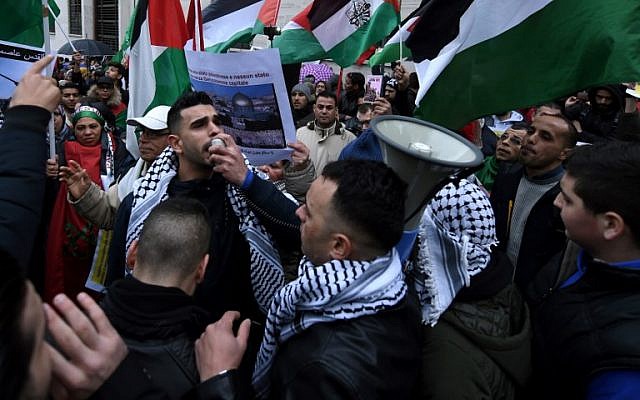 Demonstrators shout slogans and wave Palestinian flags during a demonstration in front of the US Embassy in Rome on December 9, 2017, against US President Donald Trump's recognition of Jerusalem as Israel's capital. (AFP PHOTO / FILIPPO MONTEFORTE) Demonstrators shout slogans and wave Palestinian flags during a demonstration in front of the US Embassy in Rome on December 9, 2017, against US President Donald Trump's recognition of Jerusalem as Israel's capital. (AFP PHOTO / FILIPPO MONTEFORTE)
