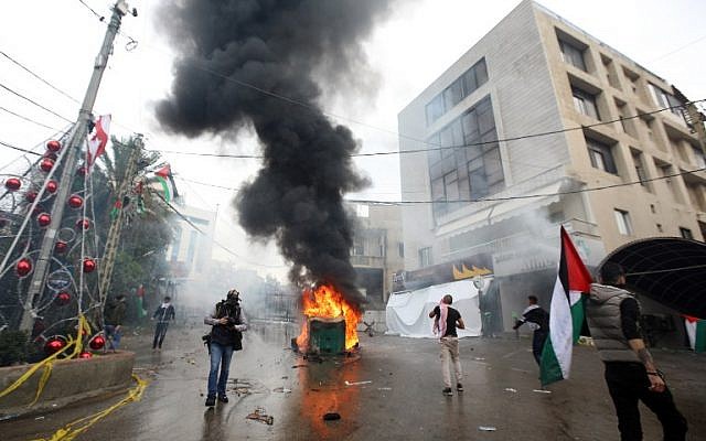 Lebanese security forces fire tear gas to disperse protestors as a fire burns in a dumpster during a demonstration outside the US embassy in Awkar, on the outskirts of the Lebanese capital Beirut, December 10, 2017. (ANWAR AMRO/AFP) Lebanese security forces fire tear gas to disperse protestors as a fire burns in a dumpster during a demonstration outside the US embassy in Awkar, on the outskirts of the Lebanese capital Beirut, December 10, 2017. (ANWAR AMRO/AFP)