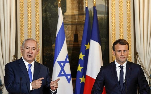 Israeli Prime Minister Benjamin Netanyahu speaks as French President Emmanuel Macron looks on during a joint news conference following their meeting at the Elysee Palace in Paris on December 10, 2017. (AFP PHOTO / POOL / PHILIPPE WOJAZER) Israeli Prime Minister Benjamin Netanyahu speaks as French President Emmanuel Macron looks on during a joint news conference following their meeting at the Elysee Palace in Paris on December 10, 2017. (AFP PHOTO / POOL / PHILIPPE WOJAZER)