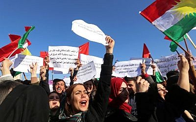 Iraqi Kurdish students from Salahaddin University wave the Kurdish flag as they demonstrate in Arbil, the capital of the autonomous Iraqi Kurdistan region, on December 11, 2017, against the Iraqi prime minister. (AFP Photo/Safin Hamed)
