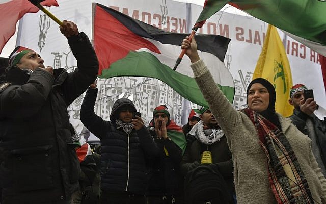 People wave Palestinian flags during a protest gathering near the EU headquarters in Brussels on December 11, 2017. (John Thys/AFP) People wave Palestinian flags during a protest gathering near the EU headquarters in Brussels on December 11, 2017. (John Thys/AFP)