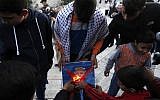 Palestinian youths set a portrait of US President Donald Trump on fire after his  recognition of Jerusalem as Israel's capital, during a demonstration outside Damascus Gate in Jerusalem's Old City on December 11, 2017.  (AFP/AHMAD GHARABLI)