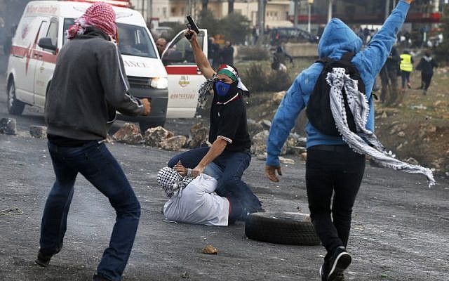 Undercover Israeli policemen detain Palestinian protesters during clashes in the West Bank city of Ramallah on December 13, 2017. (Abbas Momani/AFP)