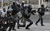 Illustrative: Border Police officers take aim at Palestinian rioters during clashes near the West Bank Qalandiya checkpoint, on the outskirts of Ramallah, on December 15, 2017. (Abbas Momani/AFP)