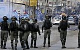 Border Police officers take aim at Palestinian rioters during clashes near the West Bank Qalandiya checkpoint, on the outskirts of Ramallah, on December 15, 2017. (Abbas Momani/AFP)