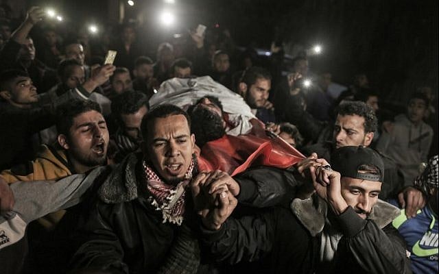 Palestinians carry the body of Ibrahim Abu Thurayeh into al-Shifa hospital in Gaza City on December 15, 2017. (AFP Photo/Mahmud Hams) Palestinians carry the body of Ibrahim Abu Thurayeh into al-Shifa hospital in Gaza City on December 15, 2017. (AFP Photo/Mahmud Hams)