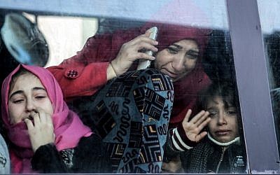 A Palestinian woman and child bid farewell through the window of a bus in Khan Younis in the southern Gaza strip on December 16, 2017, prior to their departure for the Rafah border crossing with Egypt. (AFP Photo/Said Khatib)