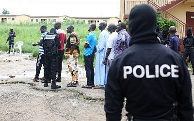 Police question detained Muslim retail traders on December 17, 2017 in Libreville, following a knife attack on two Danish nationals.  (AFP PHOTO / Steve JORDAN)