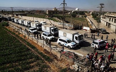 Illustrative: This photo taken on July 30, 2017 shows a United Nations and Syrian Arab Red Crescent convoy delivering aid packages in the rebel-held town of Nashabiyah in eastern Ghouta for the first time in five years. (AFP Photo/Amer Almohibany)