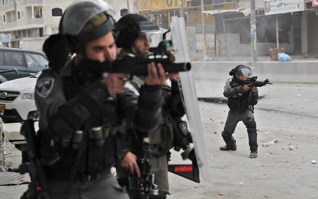 Israeli forces keep position during clashes with Palestinian protesters near the Qalandiya checkpoint in the West Bank on December 20, 2017 as protests continue following the US president's recognition of Jerusalem as Israel's capital. (AFP PHOTO / Thomas COEX)