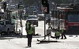 A white SUV sits in the middle of the road as police and emergency personnel work at the scene of where a car ran over pedestrians in Flinders Street in Melbourne on December 21, 2017. (AFP/ Mark Peterson)