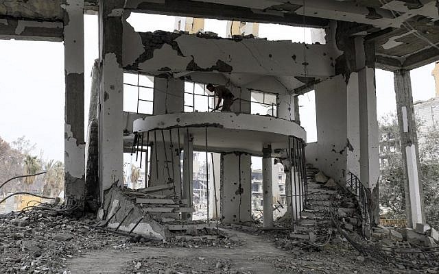 A member of the Roj Mine Control Organisation uses a handheld detector to look for explosives in the heavily-damaged Armenian Catholic Church of the Martyrs in the city center of the eastern Syrian city of Raqqa on December 20, 2017. (AFP PHOTO / Delil Souleiman) A member of the Roj Mine Control Organisation uses a handheld detector to look for explosives in the heavily-damaged Armenian Catholic Church of the Martyrs in the city center of the eastern Syrian city of Raqqa on December 20, 2017. (AFP PHOTO / Delil Souleiman)