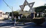 A woman walks across Israel square in Guatemala City on December 27, 2017 (AFP PHOTO / Orlando ESTRADA)