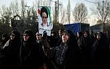 Iranians chant slogans as they march in support of the government near the Imam Khomeini grand mosque in the capital Tehran on December 30, 2017.
Tens of thousands of regime supporters marched in cities across Iran in a show of strength for the regime after two days of angry protests directed against the country's religious rulers.  (AFP PHOTO / TASNIM NEWS / HAMED MALEKPOUR)