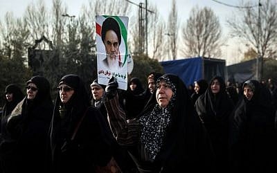 Iranians chant slogans as they march in support of the government near the Imam Khomeini grand mosque in the capital Tehran on December 30, 2017.
Tens of thousands of regime supporters marched in cities across Iran in a show of strength for the regime after two days of angry protests directed against the country's religious rulers.  (AFP PHOTO / TASNIM NEWS / HAMED MALEKPOUR)