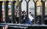 Iranian students scuffle with police at the University of Tehran during a demonstration driven by anger over economic problems, in the capital Tehran on December 30, 2017.  (AFP/ STR)