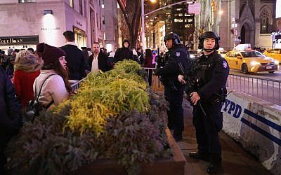 Police stand guard near the Rockefeller Center Christmas tree on December 12, 2017, in New York City. (John Moore/Getty Images/AFP