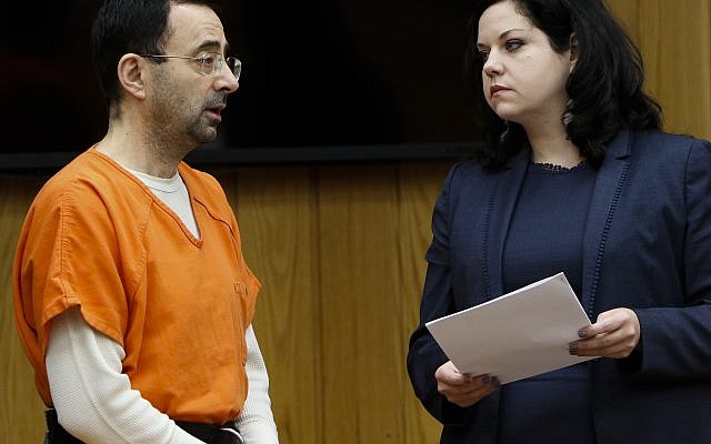 Former sports doctor Larry Nassar, left, stands with his attorney Shannon Smith as he pleads guilty to three counts of first-degree criminal sexual conduct Wednesday, Nov. 29, 2017, in Judge Janice Cunningham's courtroom in Eaton County, Mich. (Matthew Dae /Lansing State Journal via AP) Former sports doctor Larry Nassar, left, stands with his attorney Shannon Smith as he pleads guilty to three counts of first-degree criminal sexual conduct Wednesday, Nov. 29, 2017, in Judge Janice Cunningham's courtroom in Eaton County, Mich. (Matthew Dae /Lansing State Journal via AP)