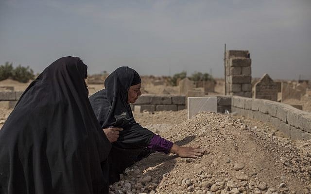 Fatima Ahmed Aswad cries as she touches the grave of her 15-year-old daughter Sana in Mosul on October 9, 2017. Sana's death, like those of many civilians killed during the final battle to drive out Islamic State extremists, was not recorded until her body could be exhumed. An AP investigation found between 9,000 and 11,000 civilians died during the final battle to drive out Islamic State extremists. (AP Photo/Bram Janssen) Fatima Ahmed Aswad cries as she touches the grave of her 15-year-old daughter Sana in Mosul on October 9, 2017. Sana's death, like those of many civilians killed during the final battle to drive out Islamic State extremists, was not recorded until her body could be exhumed. An AP investigation found between 9,000 and 11,000 civilians died during the final battle to drive out Islamic State extremists. (AP Photo/Bram Janssen)