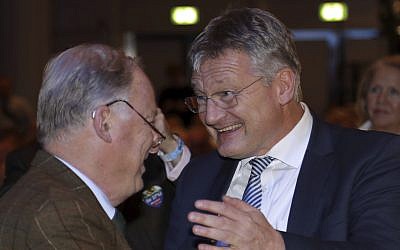 The new elected party chairmen Joerg Meuthen, right, and Alexander Gauland shake hands during a party convention of the Alternative for Germany, AfD, party in Hannover, Germany, Saturday, Dec. 2, 2017. (AP Photo/Michael Sohn)